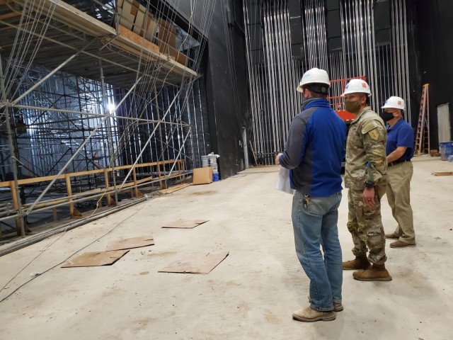 Command Sgt. Maj. Raymond Harris, the 1st Infantry Division senior enlisted leader toured the Junction City High School construction project April 9, 2021.  Cody Simon, wearing the Hutton Construction shirt, is the general superintendent with Hutton Construction and explained the engineering that went into the project. Several cement walls were cast on-site and hoisted into place with a crane, saving the district on transportation and the cost of off-site labor.