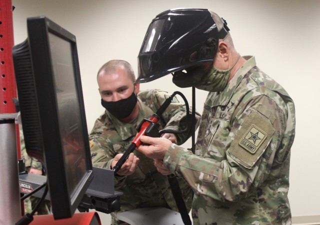 Gen. James McConville, the 40th Chief of Staff of the U.S. Army (right), uses a welding simulator at the Ordnance School’s Cohen Hall Thursday, April 22, 2021 at Fort Lee, Va. McConville visited the Army post reviewing Combined Arms Support...