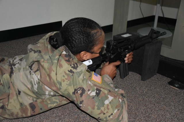 Staff Sgt. Ulita Knight, U.S. Army Human Resources Command test analyst NCO in Systems Integration Branch conducts weapon qualifications on the Engagement Skills Trainer (EST) 2000 as one of the Best Warrior Competition events, Ft. Knox, Ky.