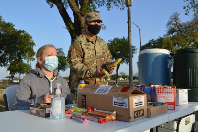 Army Sgt. Velvettina Noriega, a member of Brooke Army Medical Center’s Soldier Recovery Unit, and Army Staff Sgt. Jose Pagayon, a squad leader in the SRU, had out healthy treats and drinks along the  course for Soldiers participating in the April 10 Bataan Death March remembrance event on Joint Base San Antonio-Fort Sam Houston. The Fort Sam Houston event, which was part of the overall national event normally held in New Mexico but done virtually this year due to the pandemic, pays respect to the American and Filipino Soldiers who were forced to march more than 65 miles under brutal conditions. 
(U.S. Army photo by Daniel J. Calderón)