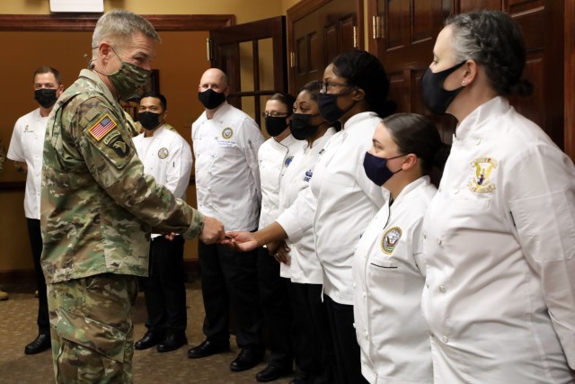 Gen. James C. McConville, Army chief of staff awards coins to members of the Joint Culinary Center of Excellence during a buffet luncheon Thursday, April 22, 2021 at Fort Lee, Va.  McConville visited the Army post reviewing Combined Arms Support...