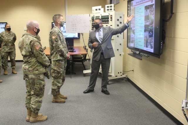 Jose Hernendez, the director of the Petroleum and Water Department (right), briefs Gen. James McConville, the 40th Chief of Staff of the U.S. Army (middle) and Maj. Gen. Rodney Fogg, commanding general of U.S. Army Combined Arms Support Command...