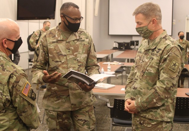 Brig. Gen. James M. Smith, the 31st Chief of Transportation and president of Army Logistics University (center) speaks to Gen. James McConville, the 40th Chief of Staff of the U.S. Army (right) and Maj. Gen. Rodney Fogg, commanding general of U.S....