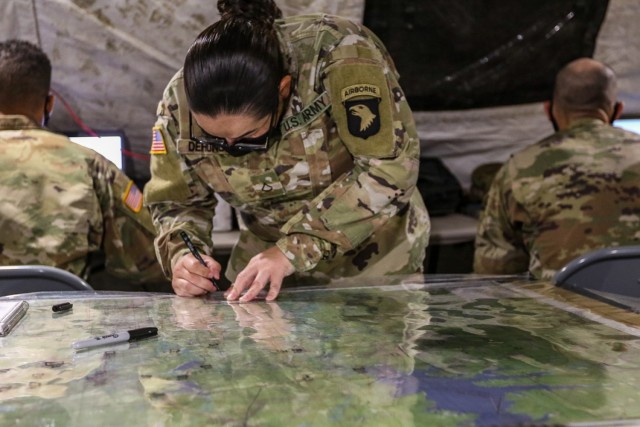 Private First Class Jessica Dehonor, intelligence analyst assigned to D Company, 326th Brigade Engineer Battalion, 1st Brigade Combat Team, 101st Airborne Division (Air Assault), plots named areas of interest on a map April 14 during MITS II at Johnson Field. MITS II is an intelligence field training exercise that trains and validates every intelligence specialty within the brigade to prepare intelligence Soldiers to create a common operating picture for their commander.