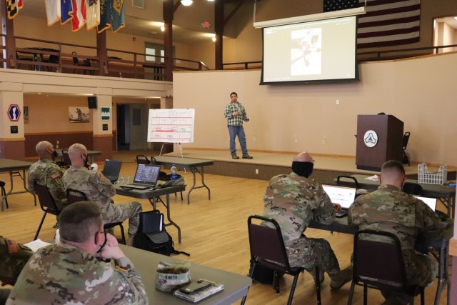 Brad Vieth, range safety officer with the Fort McCoy Directorate of Plans, Training, Mobilization and Security (DPTMS), briefs 23 service members attending the DPTMS Training Workshop on April 8, 2021, in building 905 at Fort McCoy, Wis. This was the first workshop held by the directorate to assist unit representatives with the processes and requirements to schedule and hold training at Fort McCoy. The workshop took place April 7-8 and participants learned about range safety, range operations, range maps, and more. (U.S. Army Photo by Scott T. Sturkol, Public Affairs Office, Fort McCoy, Wis.)