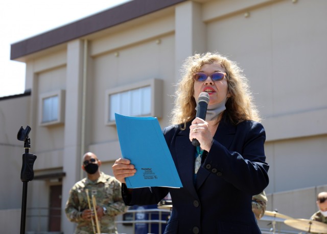 Jennifer Partridge, director of U.S. Army Garrison Japan Army Community Service, reads the Installation Commanders Proclamation for National Child Abuse Prevention Month during the USAG Japan ACS pinwheel planting commemoration of the month at the...