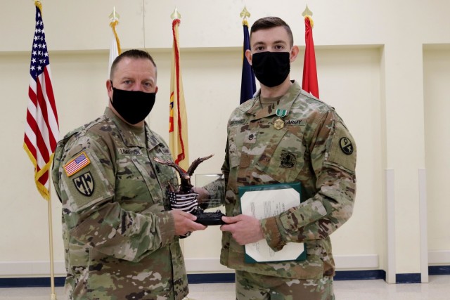 Command Sgt. Maj. James Lamberson (left) presents Staff Sgt. Trevor MacDonald the 80th Training Command's Best Warrior 2021 trophy on April 23, 2021 for his winning effort during the command’s competition in Camp Bullis, Texas. MacDonald will now prepare for and compete in the U.S. Army Reserve competition against other winners from numerous geographic and functional commands in May 2021.