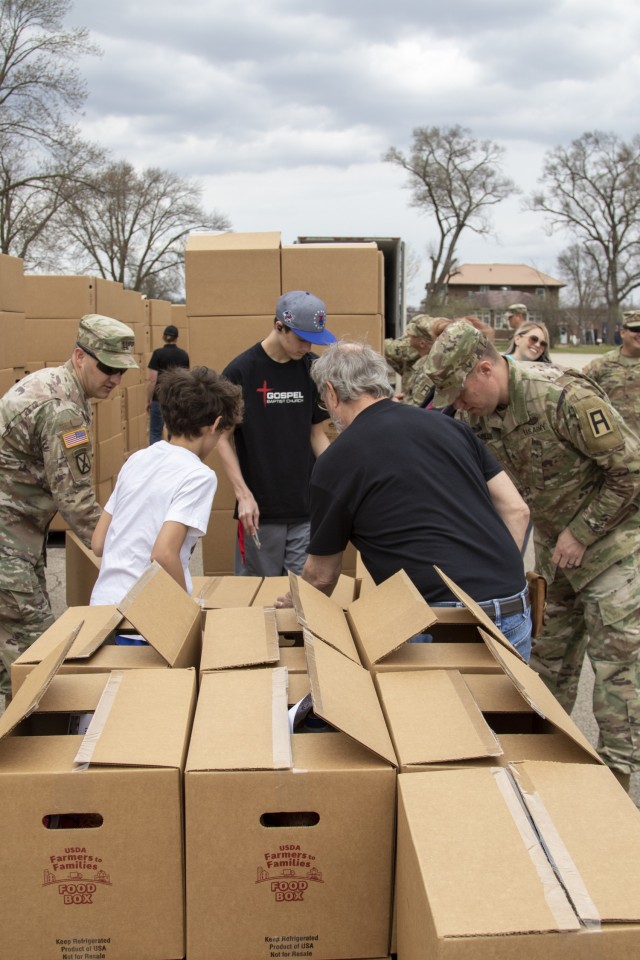Soldiers of the 181st Multifunctional Training Brigade and volunteers from the Sparta Gospel Baptist Church prepare United States Department of Agriculture Food Box boxes for distribution to the community of Sparta, Wis., April 7, 2021, at...