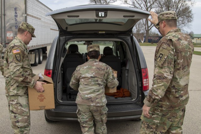 Soldiers from 1st Battalion, 337th Brigade Support Battalion, 181st Multifunctional Training Brigade, place United States Department of Agriculture Food Boxes in the van of a Sparta, Wis., community member April 7, 2021, at Memorial Park in...