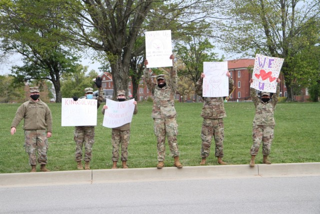 Soldiers with the 1st Theater Sustainment Command showed their support for the children attending Kingsolver Elementary School at Fort Knox, Kentucky, April 23, 2021. The Soldiers created posters and cheered on the families of the Fort Knox community in observance of the Month of the Military Child. (U.S. Army photo by Staff Sgt. Nahjier Williams, 1st TSC PAO)