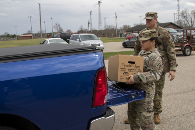 Staff Sgt. Ny Han Lam, an automated logistical specialist with 1st Battalion, 337th Brigade Support Battalion, 181st Multifunctional Training Brigade, places a United States Department of Agriculture Food Box in the truck of a Sparta, Wis.,...
