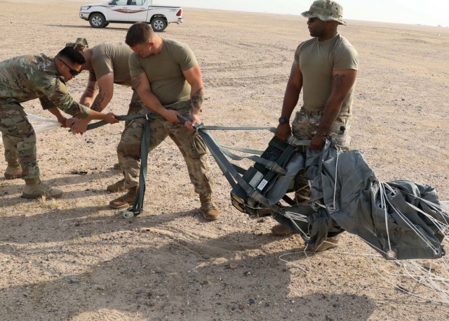 Riggers of the Fort Bragg, North Carolina, based 151st Quartermaster Company, deployed the U.S. Central Command area of responsibility in support of 1st Theater Sustainment Command, work to recover one of four Joint Precision Air Delivery System, or JPADS, units used to air drop four bundles  at the Camp Buehring, Kuwait, drop zone. The black device rigged between the parafoil and the payload is the Modular Autonomous Guidance Unit, or MAGU, which uses the lines of the chute to steer it to its programmed target. (U.S. Army photo by Neil W. McCabe)