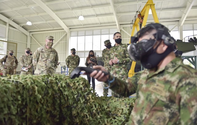 Brig. Gen. Douglas Lowrey, commander of U.S. Army Security Assistance Command, and his staff watch a virtual training session during day 4 of a key leader engagement with the Colombian Army at the Canton Norte base in Bogota, Colombia, 8 April 2021. Brig. Gen. Lowrey, and members of his staff, visited several sites to see the impact of U.S. security assistance and foreign military sales, in support of the Colombian military in defending their country from counter-narcotic and terrorist threats. (U.S. Army photo by Richard Bumgardner)