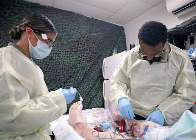 Spc. Deanza Lopez, left, and Spc. Dameon Frovarp, right, healthcare specialists assigned to Charlie Company, 2nd Battalion, 25th Brigade Support Battalion, 2nd Brigade Combat Team, 25th Infantry Division conduct Perfused Cadaver Training at the Medical Simulation Training Center on Schofield Barracks, Hawaii, April 14, 2021. The training allowed Soldiers to train on human tissue to better equip them for the battlefield.