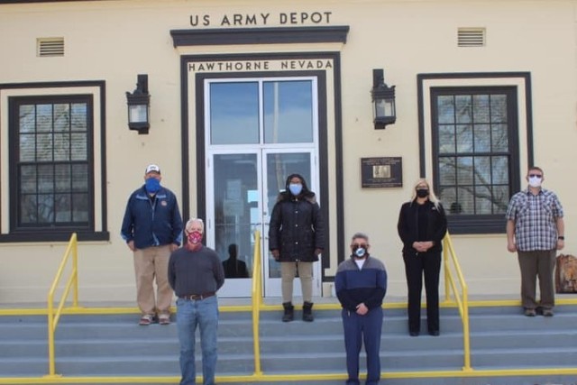 Tooele Army Depot, Deputy to the Commander, Mr. Thomas Turner, and Hawthorne Army Depot staff (from left to right, back row, Mr. Johnny Peterson, Mrs. Barbara Galloway, Ms. Courtney Isom, Mr. Tyler Viani, and front row Mr. Thomas Turner and Mr. Larry Cruz) in front of Bldg. 1, at HWAD. Both TEAD and HWAD are JMC subordinate installations. 