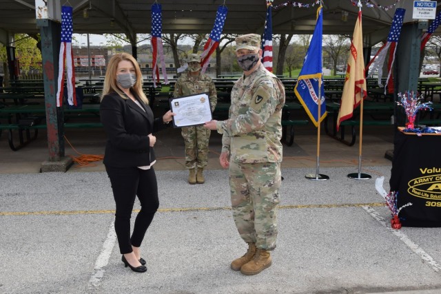 Col. Todd Allison, presents a certificate of appreciation to Tyne Jett for her work with Toys for Tots during the Volunteer Recognition Ceremony held April 20 at Memorial Park on Rock Island Arsenal.