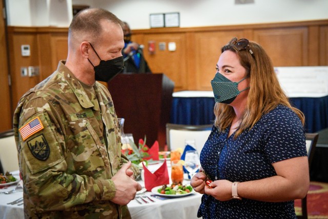 CAMP HUMPHREYS, Republic of Korea - Brig. Gen. Michael D. Roache, the deputy commanding general-sustainment for Eighth Army, speaks with Mrs. Jackie Williams, a community volunteer and organizer, after her reception of the Volunteer of the Year award during a ceremony here, April 20. Williams has dedicated countless hours to volunteering for the Humphreys Quarantine Support page, Operation Cake for Quarantine, Religious Support Office Welcome Bags initiative, Red Cross, Army Community Services, among many other organizations, helping to support, strengthen and improve the quality of life and systems of support here at Humphreys. (U.S. Army photo by Spc. Matthew Marcellus)