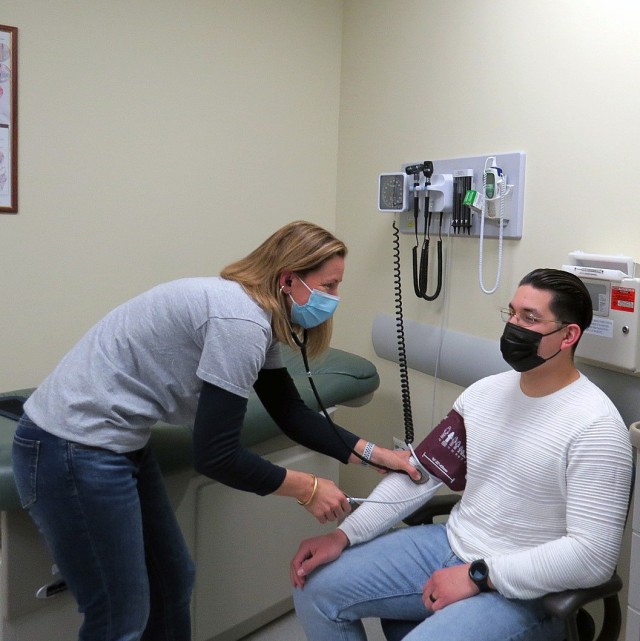 Kelli Ranalli, a Registered Nurse with U.S. Army Health Clinic Vicenza, checks the blood pressure of a patient.  (U.S. Army photo by Del Campbell)