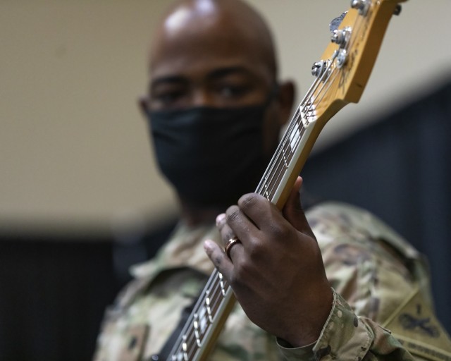 A Soldier from the 1st Armored Division Band plays the bass at Fort Bliss, Texas, April 22, 2021. Soldiers from the 1st AD Band performed at the 2021 Fort Bliss Annual Volunteer Ceremony.