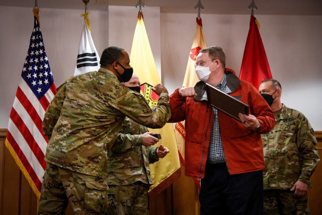 CAMP HUMPHREYS, Republic of Korea - Mr. Stephen Wahlig, right, a volunteer for the Humphreys Arts and Crafts center, bumps fists with Command Sgt. Maj. Benjamin C. Lemon Jr., the senior enlisted advisor for United States Army Garrison Humphreys, after being awarded the Civilian Employee/Contractor Volunteer of the Year award during a ceremony here, April 20. Mr. Wahlig dedicates his volunteer services as a woodworking instructor, one of the many experts from across Humphreys who improve the collective quality of life by offering their unique skillsets to the community. (U.S. Army photo by Spc. Matthew Marcellus)