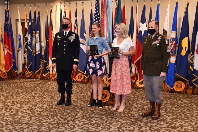 Brig. Gen. David S. Doyle, (left) Joint Readiness Training Center and Fort Polk commanding general, stands with Youth Volunteer of the Year Ruby Gross, 17, (center left), Volunteer of the Year Christina Redmond, (center right) and  Command Sgt. Maj. Michael C. Henry, post command sergeant major, after the winners received their plaques.
