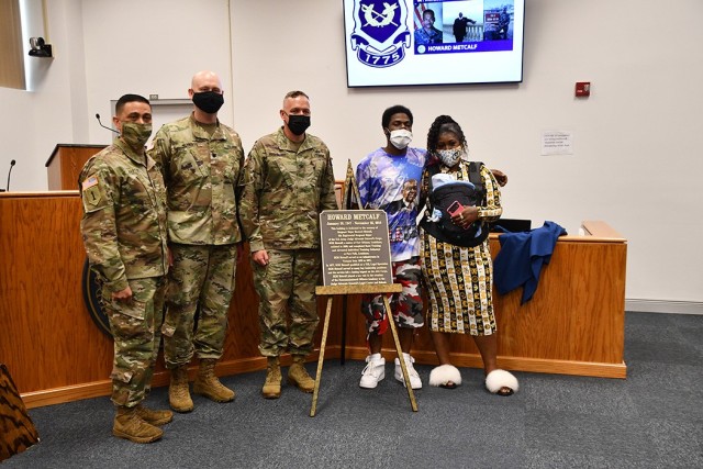 Standing behind the plaque dedicating the Fort Polk courthouse in the memory of Sgt. Maj. Howard Metcalf are Command Sgt. Maj. Osvaldo Martinez, (left) 13th Regimentl command sergeant major of the U.S. Army JAG Corps, Lt. Col. Jess Roberts, deputy staff judge advocate, Col. Ryan K. Roseberry, Fort Polk garrison commander, Desmond Metcalf, Sgt. Maj. Metcalf’s son, Jasmine Roberts, Desmond’s fiance and their son, Khalil, 3 months old.
