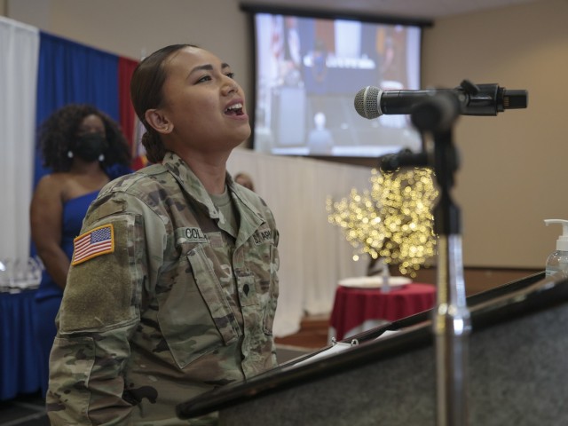 Spc. Pierre-Marie Colton, a 1st Armored Division Band Soldier, sings the Star Spangled Banner at Fort Bliss, Texas, April 22, 2021. Colton and fellow Soldier-musicians from the 1st AD Band performed during the 2021 Fort Bliss Annual Volunteer Ceremony.