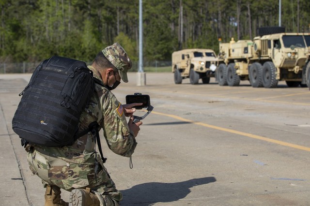Spc. Josue Patrico and Spc. Pierre Osias, both public affairs mass communications specialists assigned to 27th Public Affairs Detachment, 10th Mountain Division, work together to capture imagery of Soldiers installing vehicle MILES at Fort Polk, April 4, 2021. The Soldiers were sent to Fort Polk to help capture imagery of the 3rd Brigade Combat Team, 10th Mountain Division, Joint Readiness Training Center rotation 21-06.