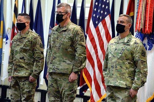 Incoming Combined Arms Center and Fort Leavenworth Command Sgt. Maj. Stephen Helton, CAC and Fort Leavenworth Commanding General Lt. Gen. James Rainey, and outgoing CAC and Fort Leavenworth Command Sgt. Maj. Eric Dostie stand at the front the room as the change of responsibility ceremony for Helton and Dostie begins April 22 at the Frontier Conference Center. Photo by Prudence Siebert/Fort Leavenworth Lamp