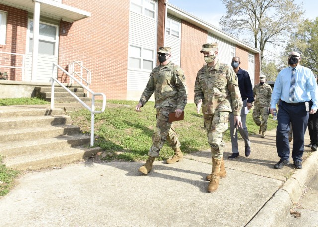 Col. Jeff Paine, U.S. Army Garrison Fort Leonard Wood commander (front right), speaks with community mayor, Staff Sgt. Ty Fogal, during a walking town hall event Tuesday in the South Leiber Heights neighborhood. Garrison leaders, along with...