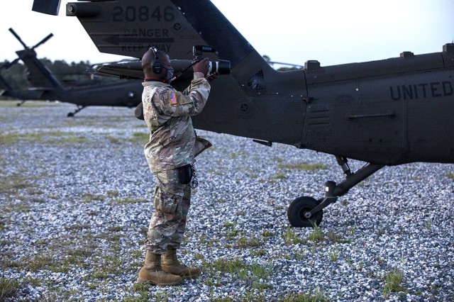 Spc. Pierre Osias, a public affairs mass communications specialist assigned to 27th Public Affairs Detachment, 10th Mountain Division, uses a DSLR camera to capture video of cold load training at Self Airfield, April 6, 2021.(U.S. Army photo by...