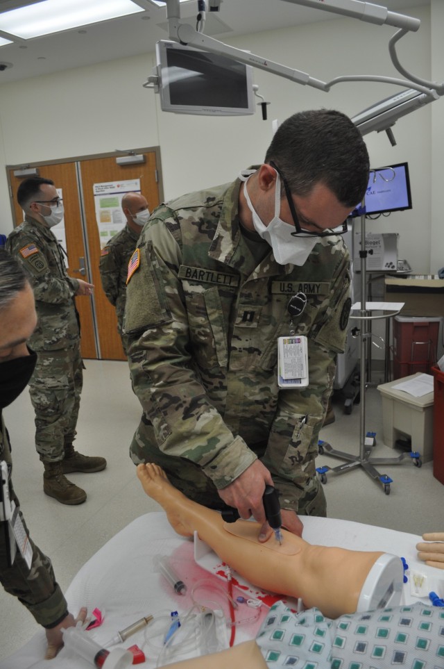Martin Army Community Hospital 3rd-year resident Capt. S. Ivan Bartlett practiced intraosseous cannulation (IO) or drilling a sturdy needle through bone to infuse fluids and blood products to critically ill patients.