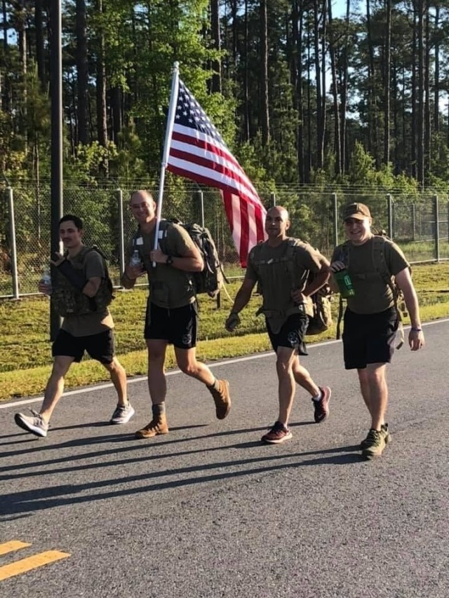 A team rucks a portion of the 4.75 mile route during the 1st Annual Capt. Nathan Nylander memorial ruck march on Wright Army Airfield, April 27 on Fort Stewart. A group of tactical air control party Airmen from Fort Stewart’s 15th Air Support...