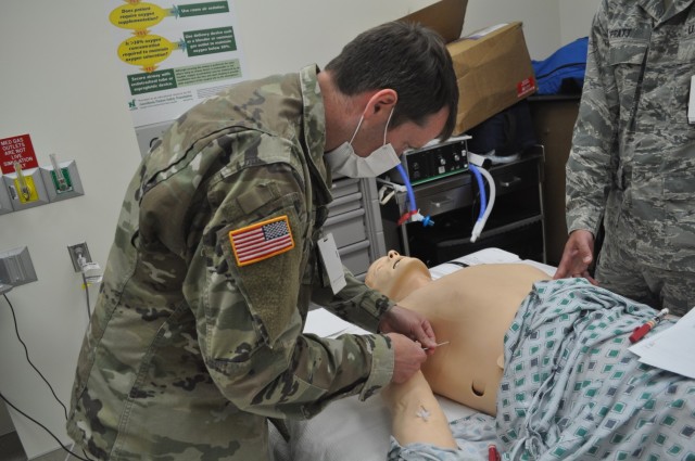 Martin Army Community Hospital's 3rd-year resident Capt. Benjamin Kight practiced a needle decompression (needle D) to quickly but temporarily relieve tension pneumothorax.