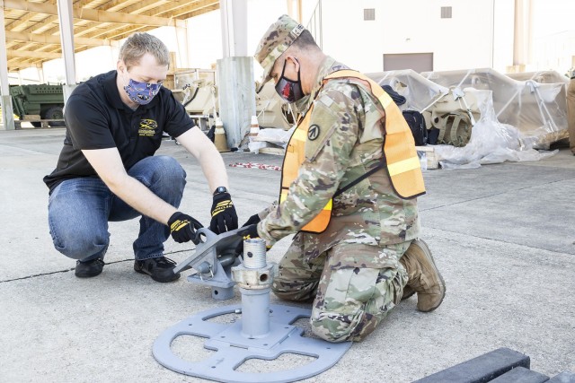 A Solider from the 757th Expeditionary Rail Center works with a civilian employee from the U.S. Army Engineer Research and Development Center to configure a landing beam during a RAIL demonstration at Anniston Army Depot.