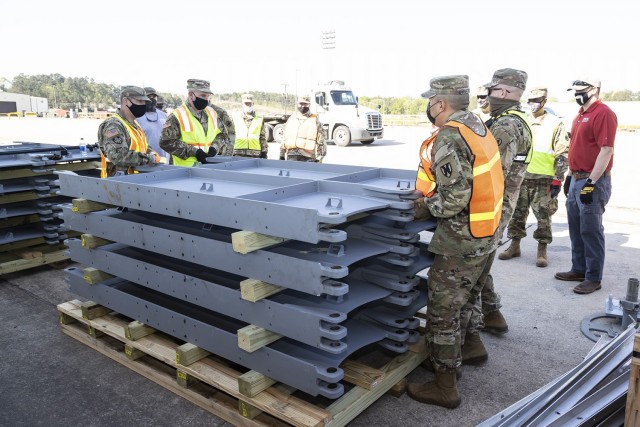 Soldiers from the 757th Expeditionary Rail Center are guided by Justin Strickler (far right), division chief at the Geotechnical and Structures Laboratory at the U.S. Army Engineer Research and Development Center, as they prepare to configure a...