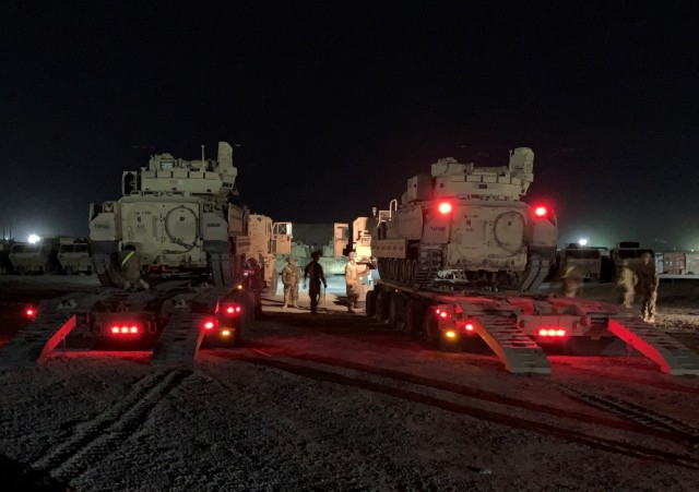 Soldiers with the 154th Heavy Composite Truck Company prepare Heavy Equipment Transport Systems loaded with Bradley Fighting Vehicles in support of the 2nd Brigade Combat Team, 1st Armored Division in Kuwait, Oct. 11, 2020.  The 311th Expeditionary Sustainment Command, which recently completed a nine-month deployment, maintained oversight of a field support and two sustainment brigades that operated across Kuwait and Iraq. 