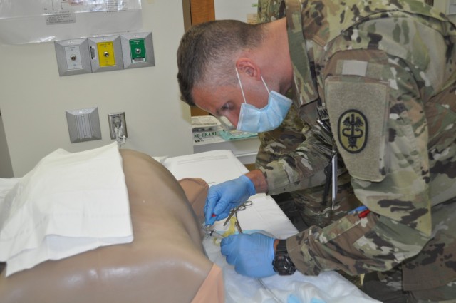 Martin Army Community Hospital's 3rd-year resident Capt. Ryan Coffey practiced inserting a chest tube, under the guidance of Emergency Physician Capt. Jacob Arnold.
