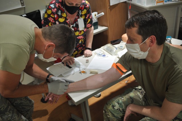 Martin Army Community Hospital 3rd-year resident Capt. Weston Pratt practiced inserting a peripheral IV in fellow 3rd-year resident Capt. Benjamin Kight under the watchful eye of Strong Team Registered Nurse Cynthia Avera.