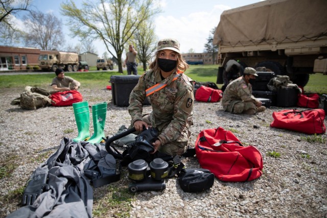 Pfc. Elliotte Villafan, a chemical, biological, radiological and nuclear (CBRN) specialist with the 140th Chemical Company, California Army National Guard, lays out her gear as she prepares to start a decontamination mission at Muscatutuck, Ind.,...
