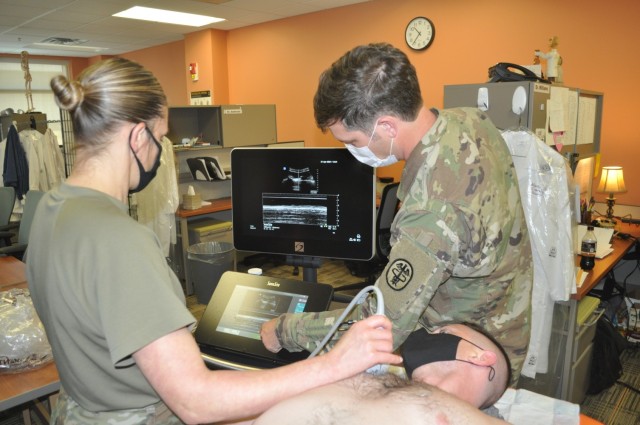 Martin Army Community Hospital 3rd-year resident Maj. Shelley Flores practiced Extended Focused Assessment with Sonography for Trauma (eFAST) readings, under the guidance of Chief of Emergency Medicine Maj. Benjamin Jennette.