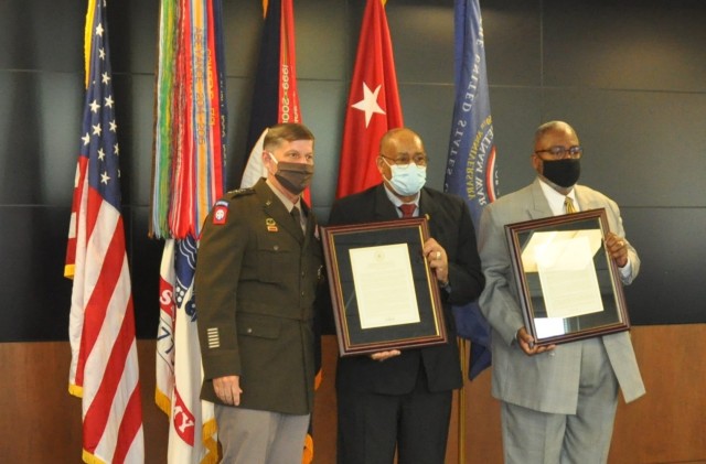 Vietnam veterans Burnie Coats, center, and David Lewis receive plaques commemorating the recognition of the 50th anniversary of the Vietnam War during a Vietnam Veterans Commemoration program hosted by Army Materiel Command at Redstone Arsenal,...