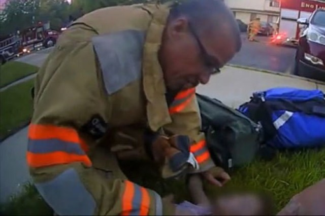 Mark Colley, volunteer firefighter and Emergency Medical Technician – New Haven, Mich. Fire Department, tends to an infant smoke inhalation victim during an emergency response Jun. 25, 2020.  Colley is the Director for Combat Support and Combat Service Support, Readiness, and Sustainment for the Integrated Logistics Support Center at U.S. Army Tank-automotive and Armaments Command Detroit Arsenal, Mich.
