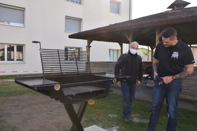 Oliver Vogt with DPW and 1st Sgt. Brian Vinci inspect the grill that DPW built for the Soldiers.