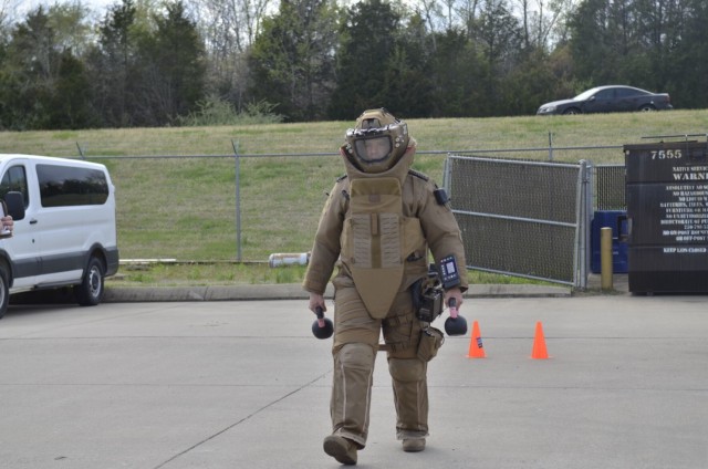 Staff Sergeant Cameron Niccum, 744th Ordnance Company, 184th Ordnance Battalion, 52nd Explosive Ordnance Group (Explosive Ordnance Disposal), tests his strength and mobility April 7 while wearing a Next Generation Advanced Bomb Suit during human factors evaluation.