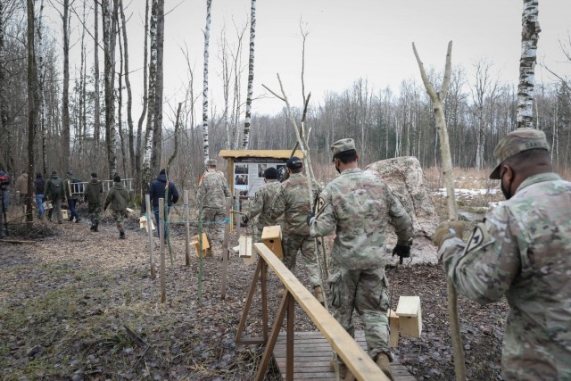 Troopers assigned to 2nd Battalion, 8th Cavalry Regiment, follow military cadets from the General Povilas Plechavicius cadet lyceum into the forest in Kaunas, Lithuania on March 13, 2021, to hang bird houses they made. The joint efforts show...