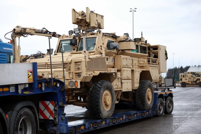 An armored vehicle assigned to the 1st Armored Brigade Combat Team, 1st Cavalry Division, sits on a flatbed trailer at Hohenfels Training Area, Germany, in preparation for transfer to Poland, Mar. 11, 2021.