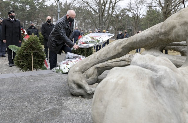 Local Polish community members lay flowers on the prisoner of war monument during the commemoration of “The Great Escape” in Zagan, Poland Mar 24. “The Great Escape” took place 77 years ago, during WWII, where 200 prisoners of war...