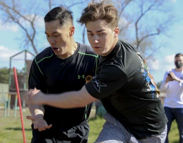 Pvt. 1st Class Ming Ko and Spc. Mason Tharp, 1st Armored Brigade Combat Team, exchange the baton during a joint sports day between the U.S. and Polish at Zagan, Poland, April 27. The events, designed to build camaraderie, test fitness and strengthen partnerships, included 4x 400 meter relays, volleyball, weightlifting competitions, and a warrior fitness challenge. The sports day between IRONHORSE Troopers and their Polish counterparts is a part of Atlantic Resolve, where approximately 6,000 Soldiers are participating in nine-month rotations, enabling the U.S. to enhance deterrence, increase readiness and support NATO.