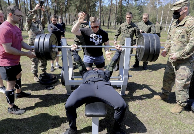 Cpt. Gabriel Perez, 50th Regional Support Group – Florida National Guard, prepares to bench-press during a joint sports day hosted by the 1st Armored Brigade Combat Team and the 11th Armored Cavalry Division – Poland at Zagan, Poland, April 27. The events, designed to build camaraderie, test fitness and strengthen partnerships, included 4x 400 meter relays, volleyball, weightlifting competitions, and a warrior fitness challenge. The sports day between IRONHORSE Troopers and their Polish counterparts is a part of Atlantic Resolve, where approximately 6,000 Soldiers are participating in nine-month rotations, enabling the U.S. to enhance deterrence, increase readiness and support NATO.
